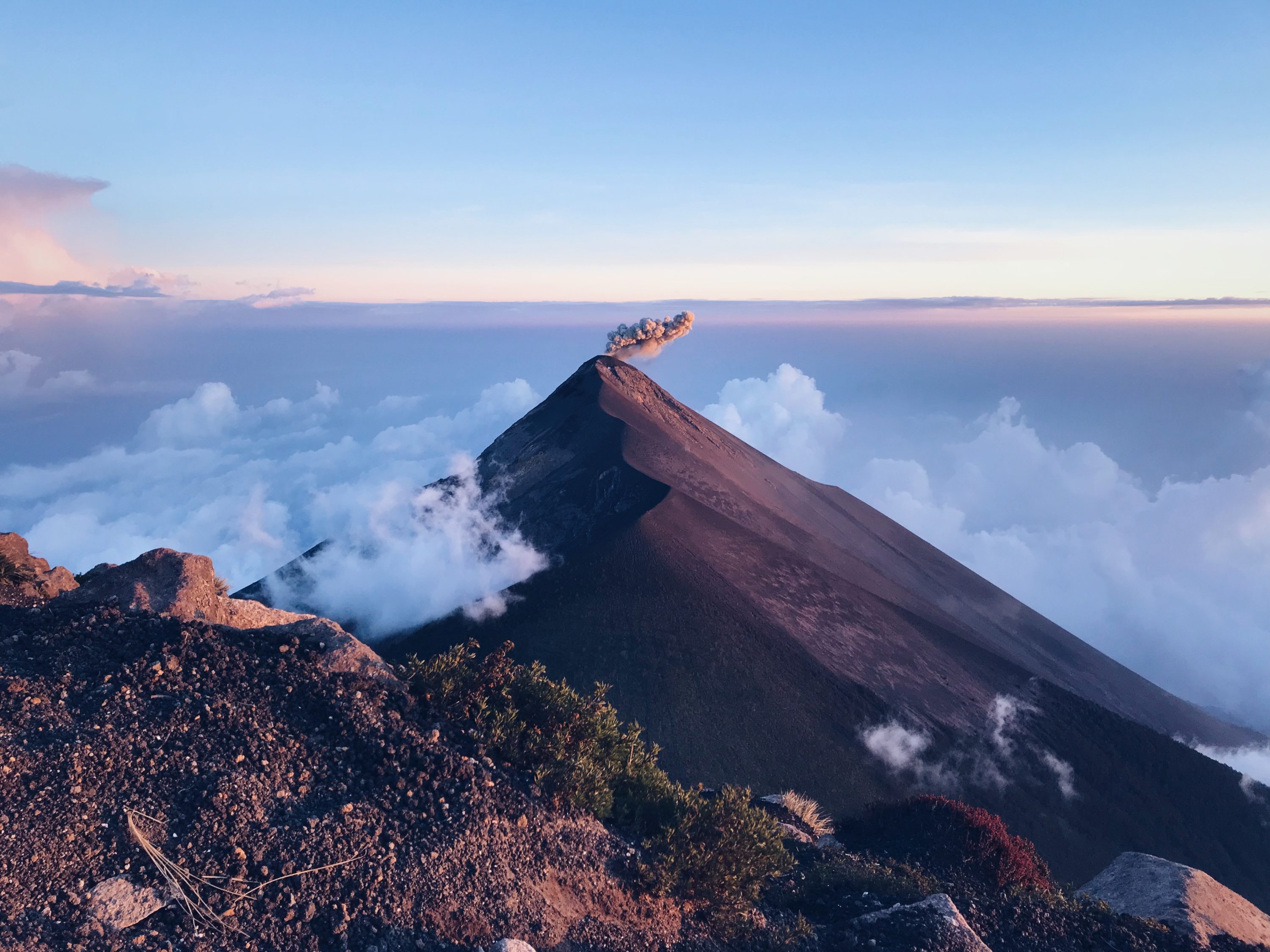 Volcano spitting out smoke at dawn